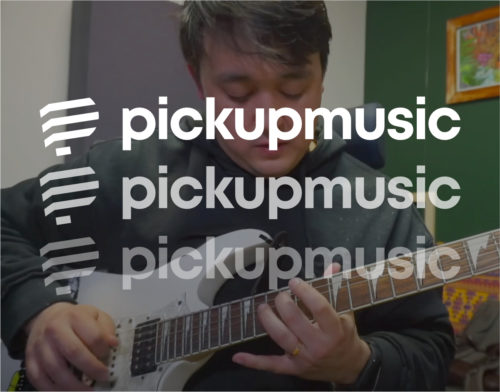 Guitarist playing an electric guitar behind the Pickup Music logo